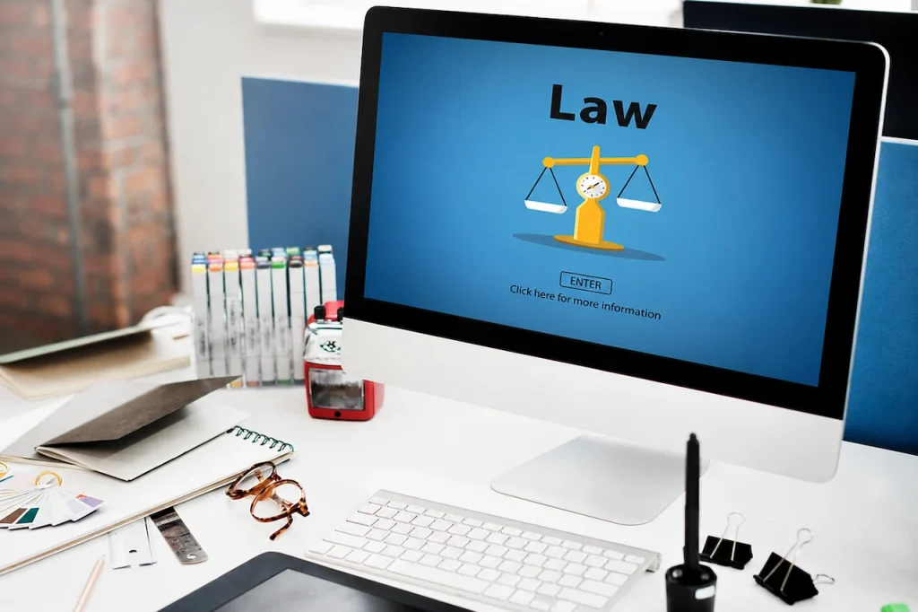 Law firm website displayed on a desktop computer with scales of justice, highlighting local SEO strategies for law firms