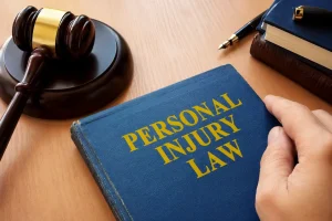 Personal injury law book with a judge’s gavel, legal documents, and office desk accessories, representing legal services and case representation