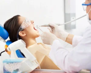 Professional dentist providing dental treatment to a patient during a routine checkup in an Ohio clinic.