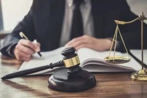 Professional law firm office featuring a judge’s gavel, legal scales, and attorney reviewing documents in Georgia.