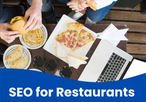 Restaurant SEO concept with food, laptop, and people dining together.
