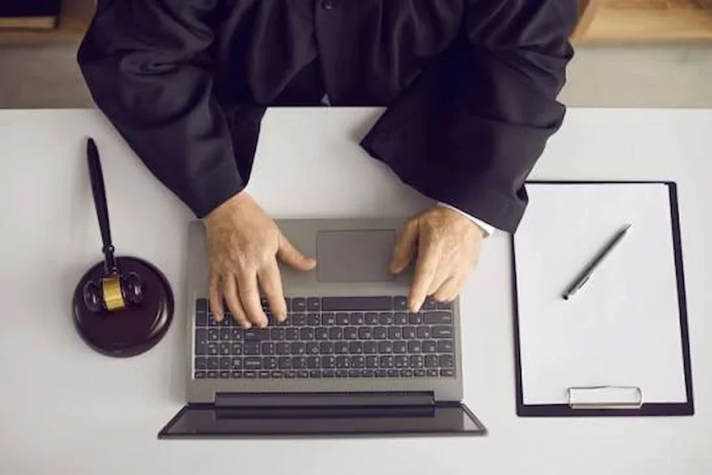 Personal injury lawyer working on a laptop at a desk, representing AI search optimization strategies for law firms.