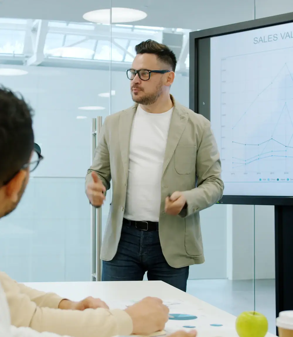 Business owner presenting a sales dashboard to his team