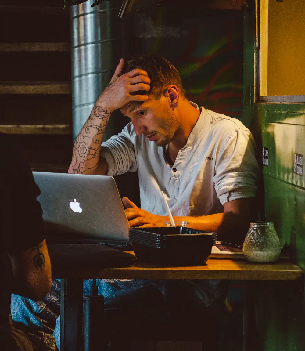 Small business owner stressed at his laptop after his Google Business Profile was suspended