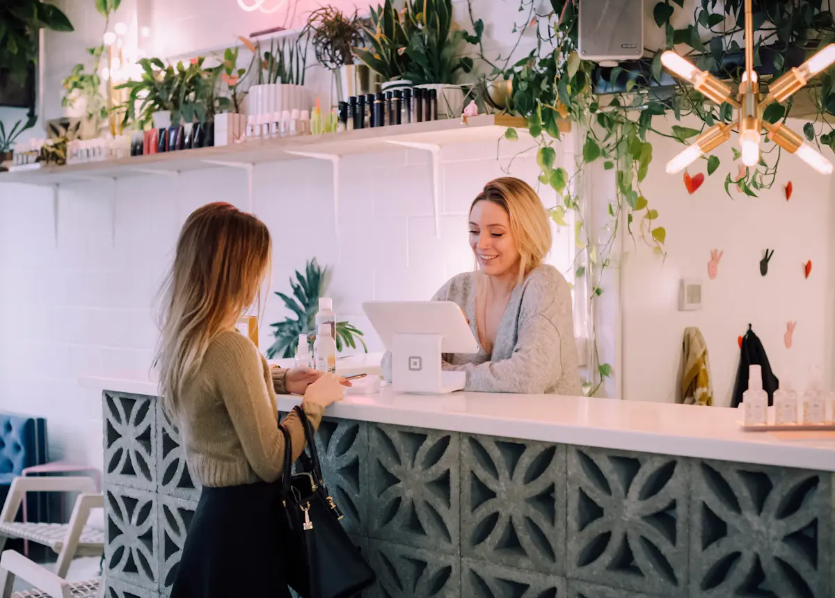 Returning customer paying at the counter of a small shop