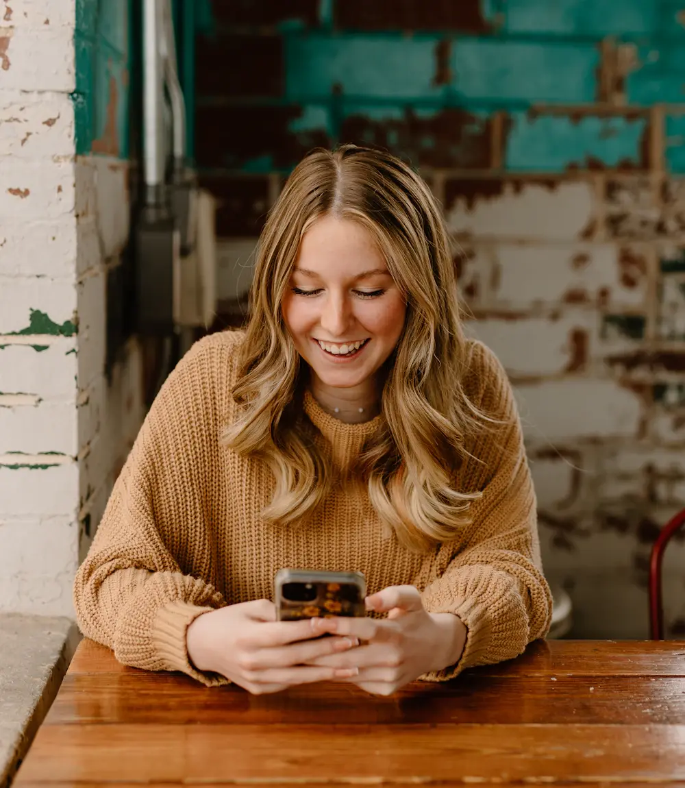 Customer reading a text message from a local business on her phone