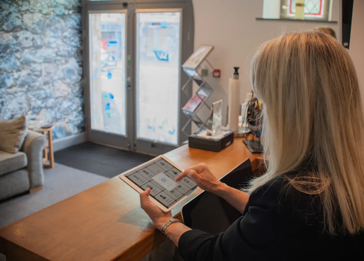 Front desk receptionist using a tablet to manage bookings