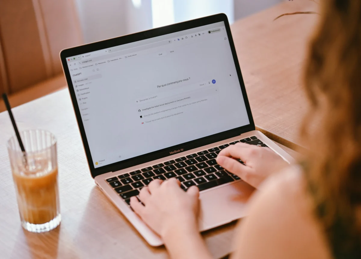 Person typing on a laptop while researching answers online