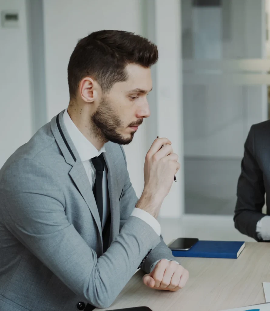 Attorneys meeting a client to discuss her case at a conference table