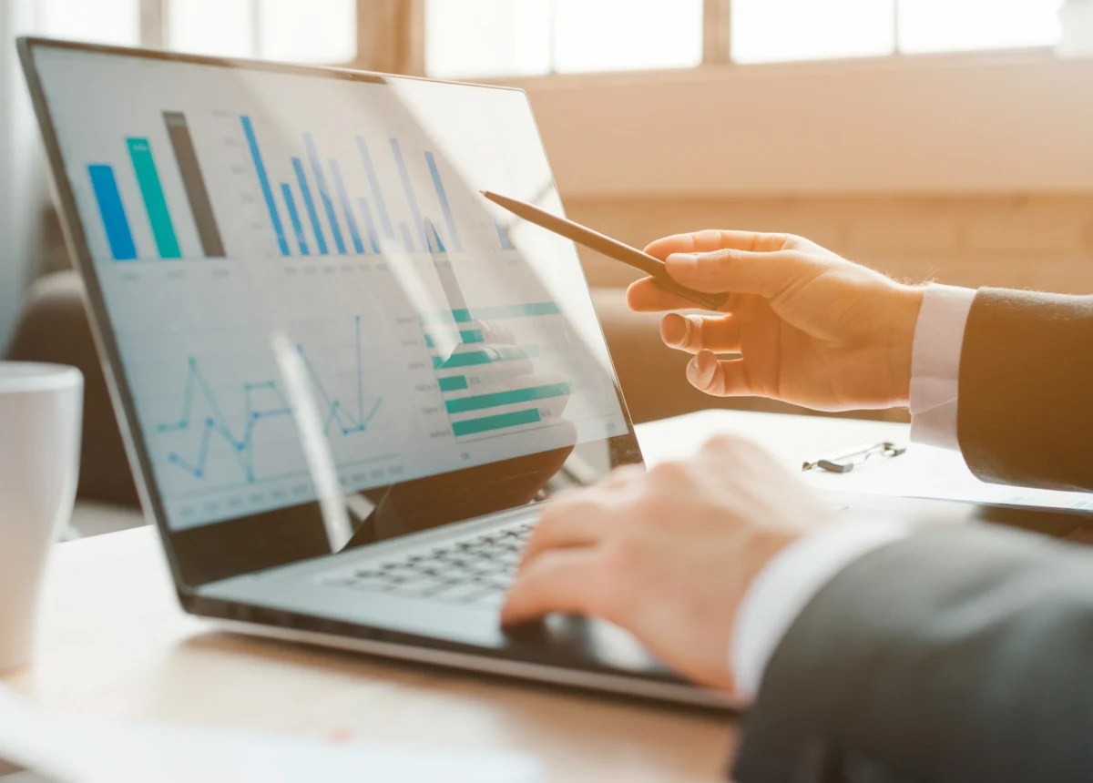 Marketer analysing AI visibility charts on a laptop